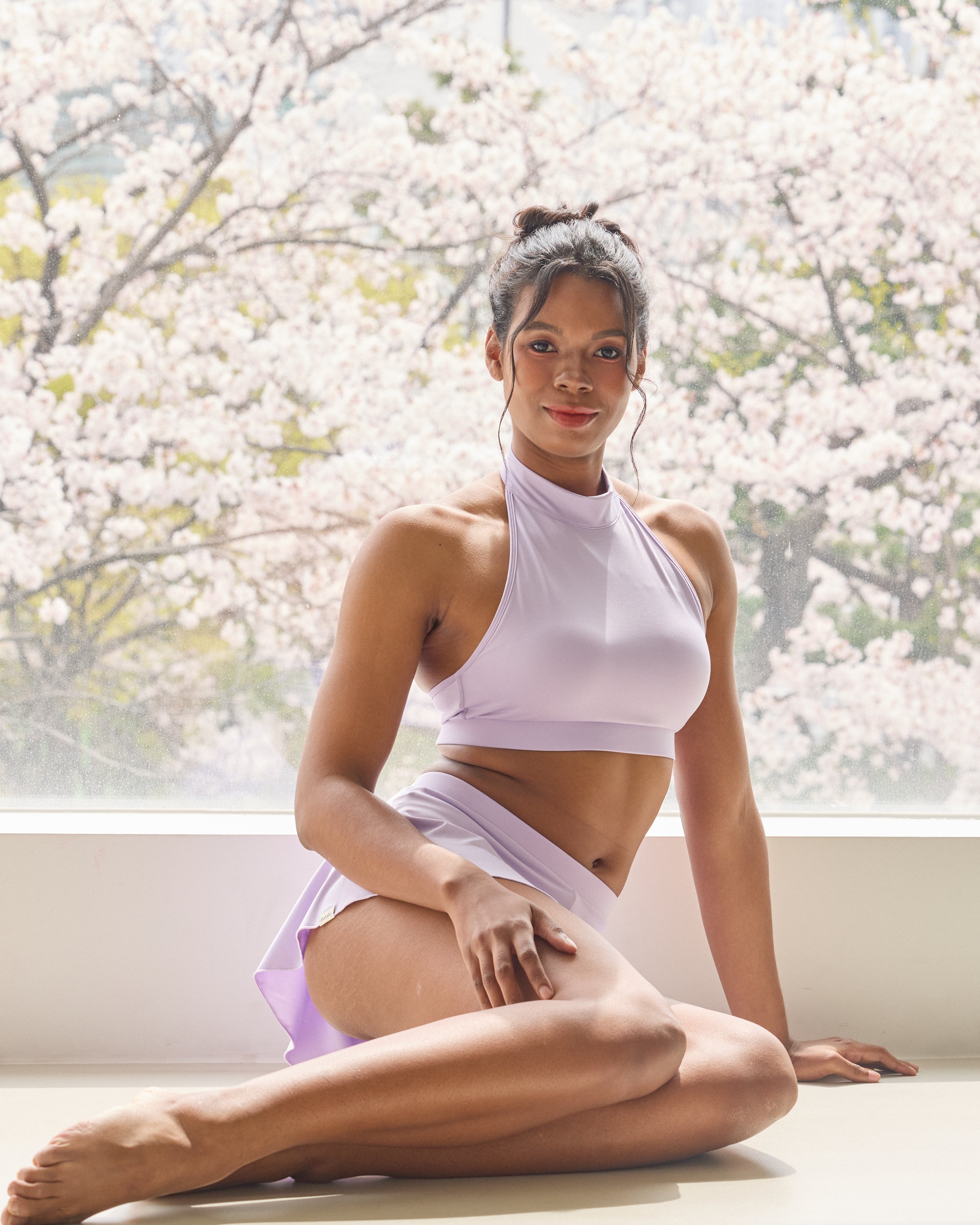 Pole dance outfit with lavender halter top and built-in skirt