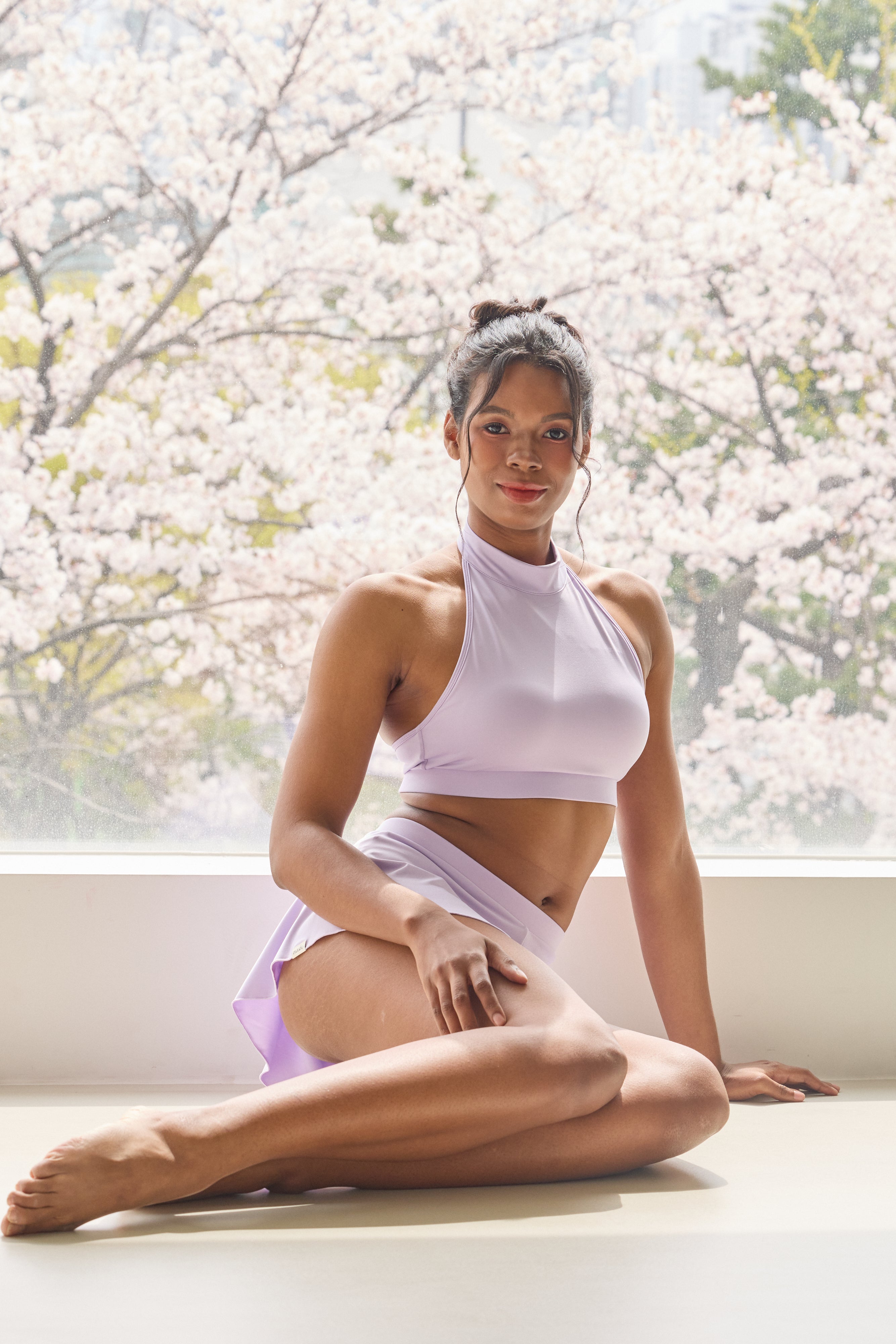 Pole dance outfit with lavender halter top and built-in skirt