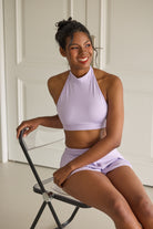 Pole dance outfit with lavender halter top and built-in skirt