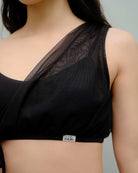 Close-up of the Metamorphosis Signature Set - Black top, featuring a mesh overlay. Sustainable polewear available in sizes S, M, L, designed for elegance and comfort.