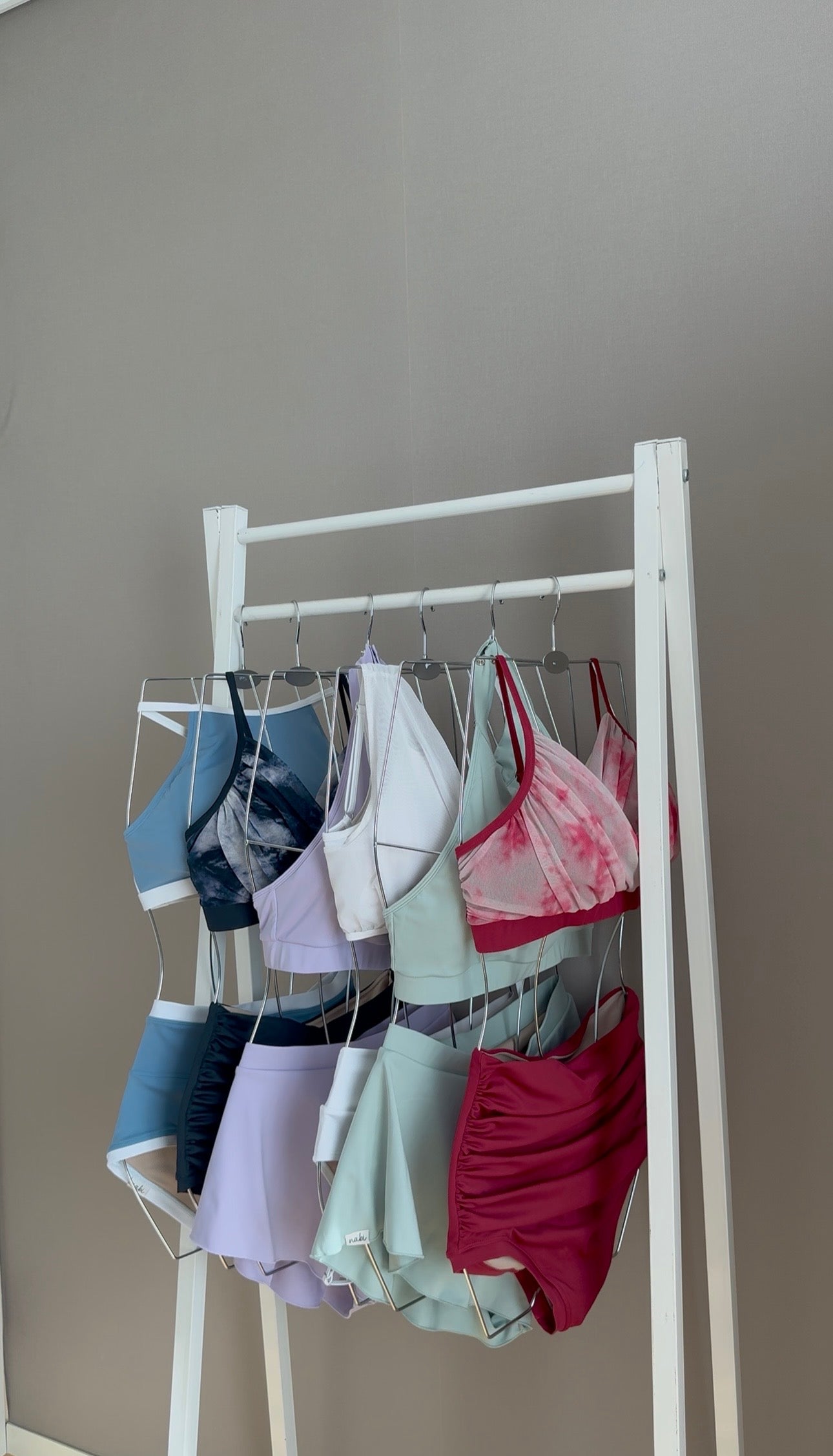 Curated rack of Nabi Polewear pieces in the Seoul showroom, highlighting clean lines, soft textures, and neutral tones
