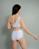 Back view of Metamorphosis Signature Set - White, available in sizes S, M, L. Sustainable polewear featuring a mesh overlay, adjustable straps, and flattering fit.